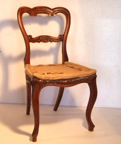 Four Victorian walnut balloon back dining chairs